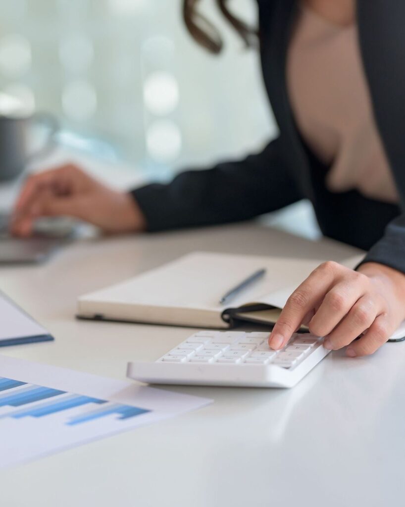 Businesswoman sitting planning analyze investment and marketing on the desk in the office.